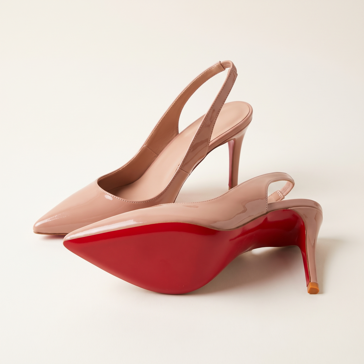 The Margaux slingback heel in Blush, one heel on its side showing the full sole