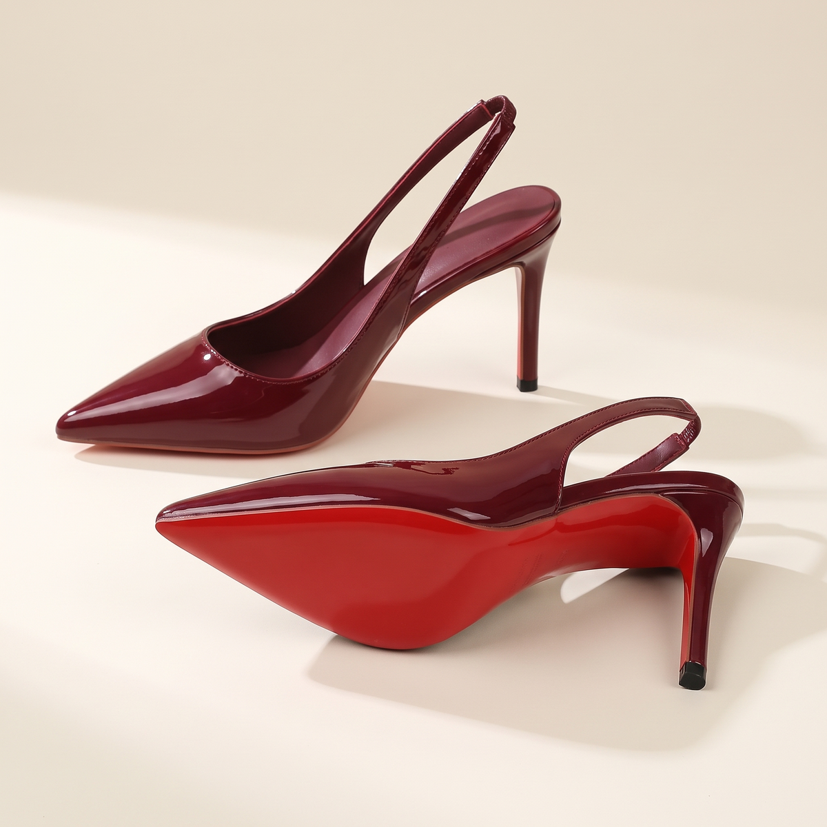 The Margaux slingback heel in Bordeaux, one heel on its side showing the full sole