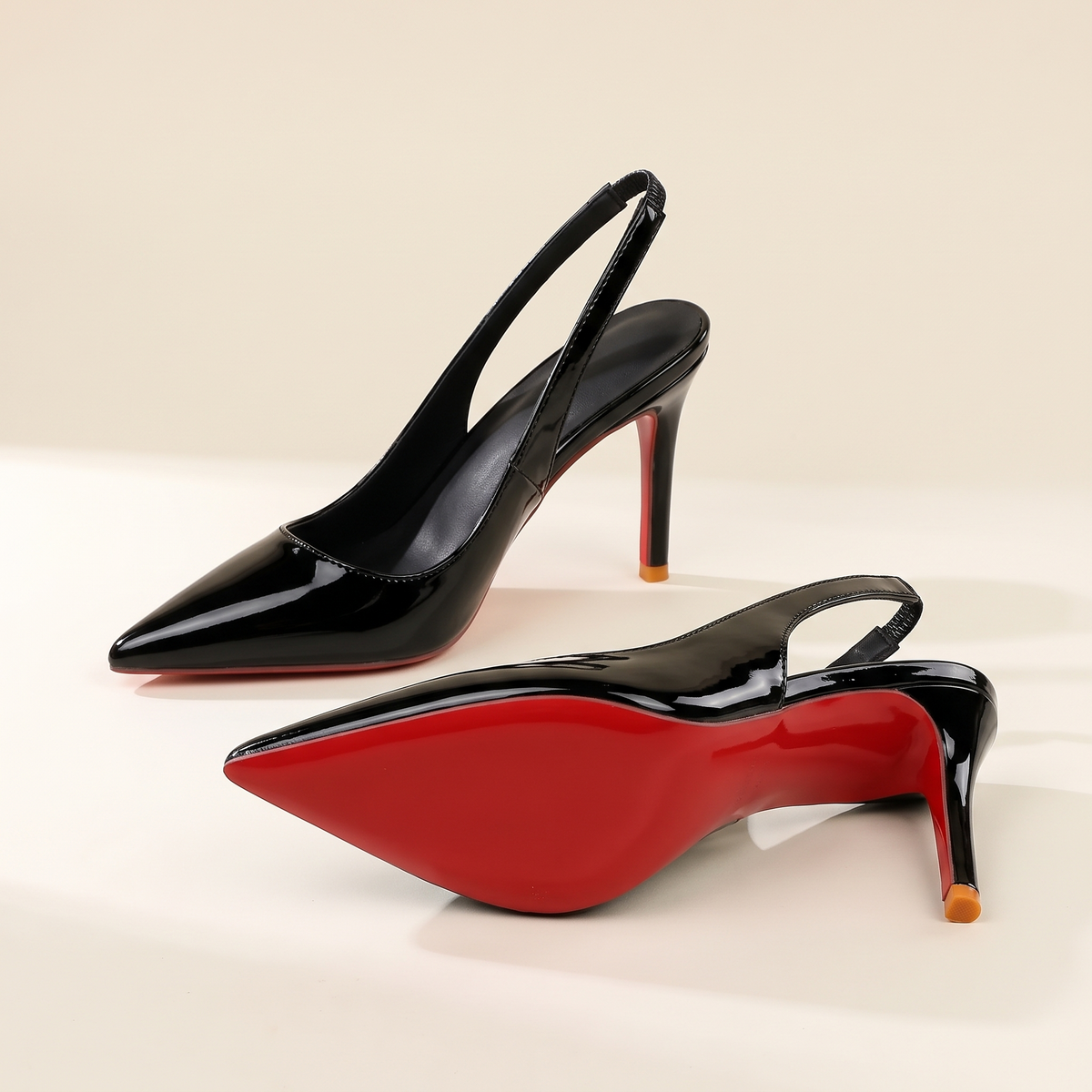 The Margaux slingback heel in Noir, one heel on its side showing the full sole